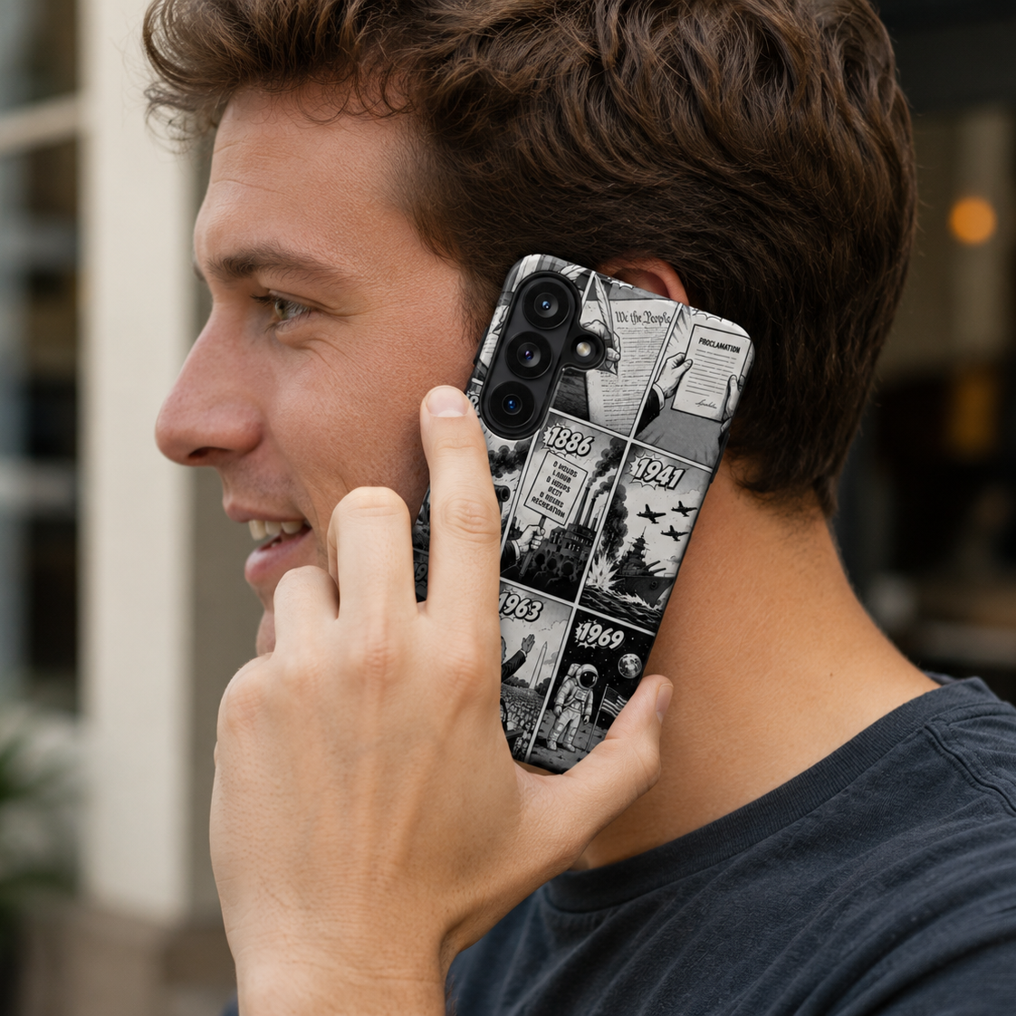 Man holding a phone with a unique case, blurred background