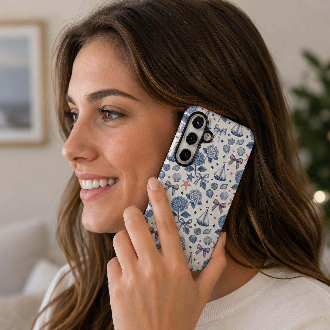 Woman holding a phone with a decorative case, smiling indoors.