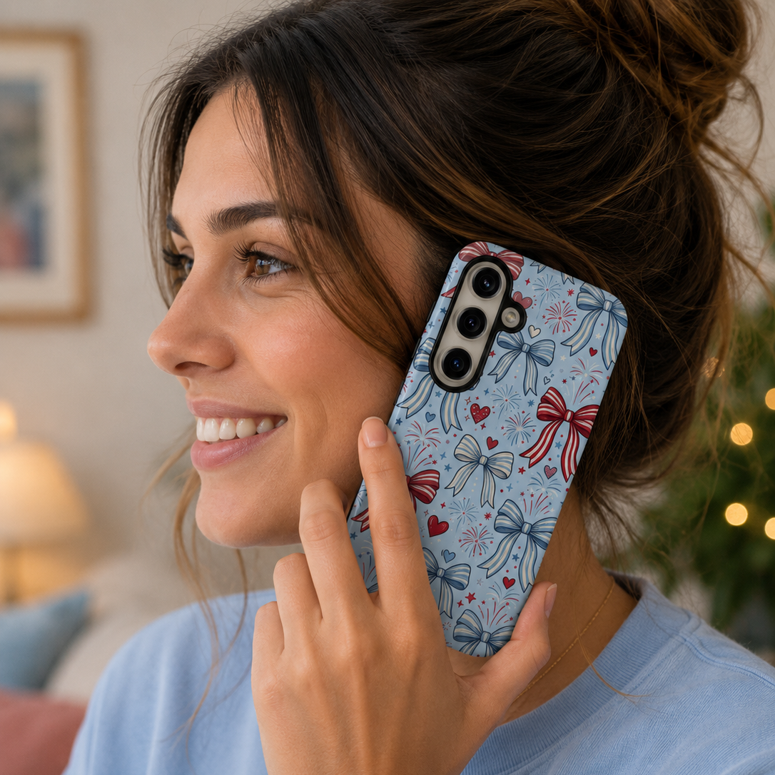 Woman holding a phone with a floral case, smiling indoors.