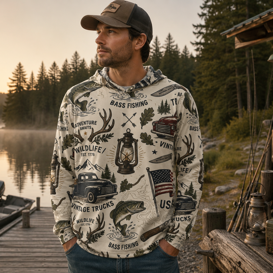 Man wearing a patterned hoodie by a lake with a cabin in the background